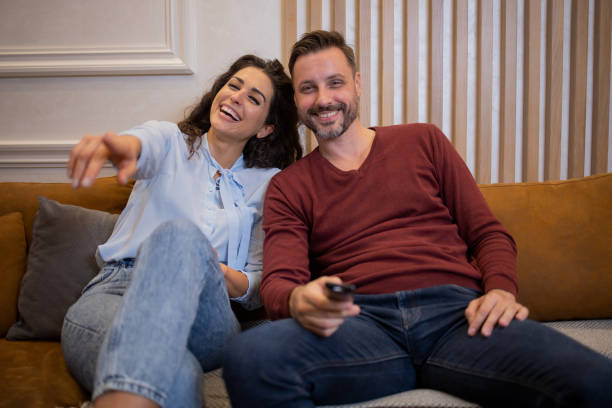 istock Young couple watching TV 1484470641