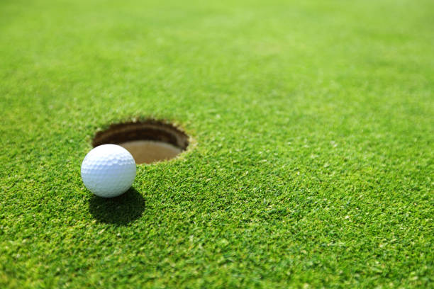 istock golf ball on lip of cup 1484472131