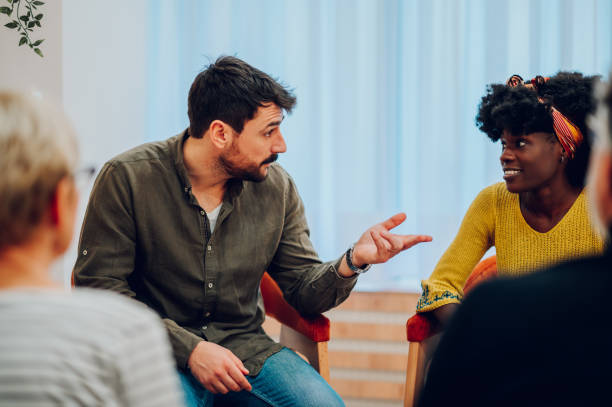 istock Multiracial people talking about their mental health on a group therapy session 1484473090