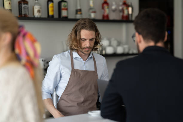 istock Communication between the bartender and the visitors of the cafe 1484473162