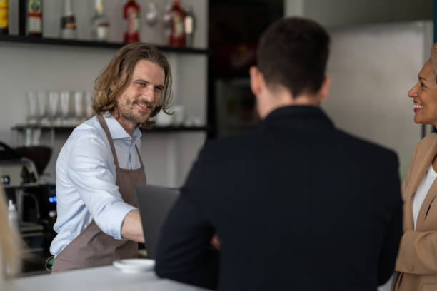 istock Communication between the bartender and the visitors of the cafe 1484473182