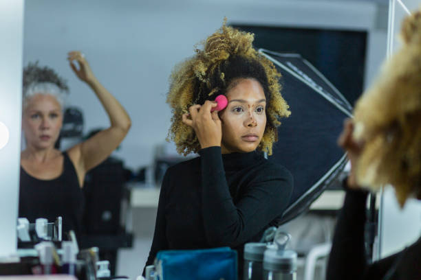 istock Makeup artist performs her work on the model before you start the photo studio 1484473951