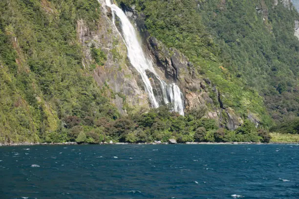 Photo of Magnificent waterfall, Milford Sound (Piopiotahi) fjord, Fiordland National Park in the south west of New Zealand's South Island. World heritage site among the world's top travel destinations