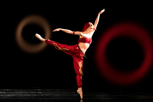 Teenager girl dancing Nikiya's role in La Bayadère (The Temple Dancer) ballet.