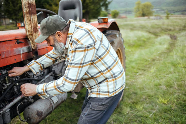 istock Farmer is repairing a tractor in the field 1484480942