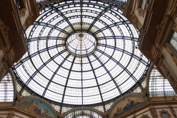 Galleria Vittorio Emanuele II in Milan. The image shows the entrance arch of the oldest active shopping arcade and a major landmark of Milan with several tourists.