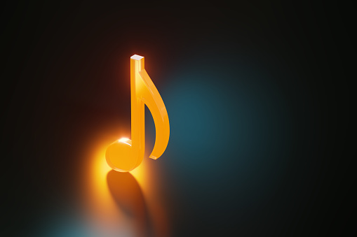 Yellow musical note on black background. Horizontal composition with copy space.