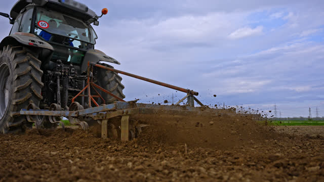 Close-up of Tractor Preparing Soil for Corn Planting