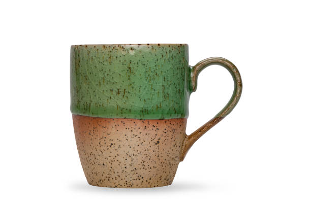 istock Empty beautiful bicolored green and brown glazed ceramic coffee mug or tea mug isolated on white background. 1484488063