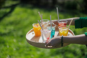 Recyclable transparent PET (polyethylene terephthalate) cups with colorful juice and soft drinks