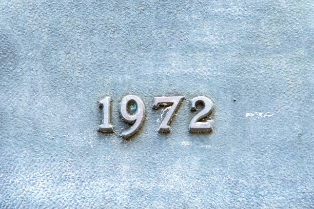 A close up of an oxidized copper plate with the year 1972