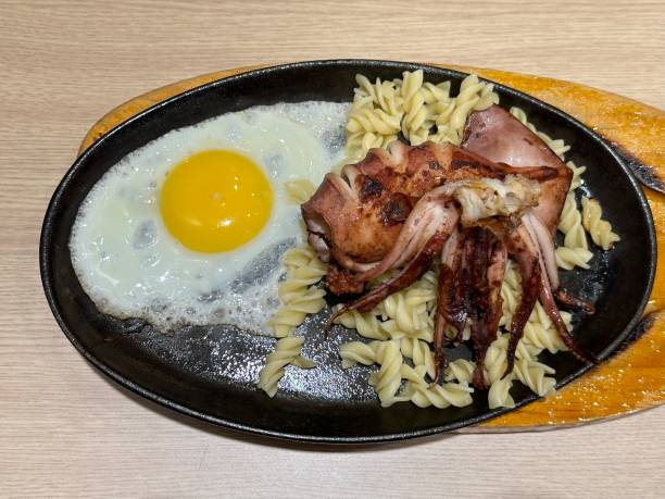 Squid steak, noodles and fried egg