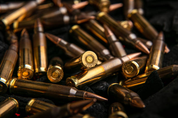 istock Cartridges for automatic carbine caliber .223 on charcoal. Ammunition for automatic and semi-automatic rifles. Dark background. 1484501968