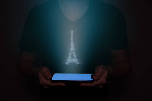 istock A man in the future holds a on which the tower Eiffel is projected. New technology. 1484505551