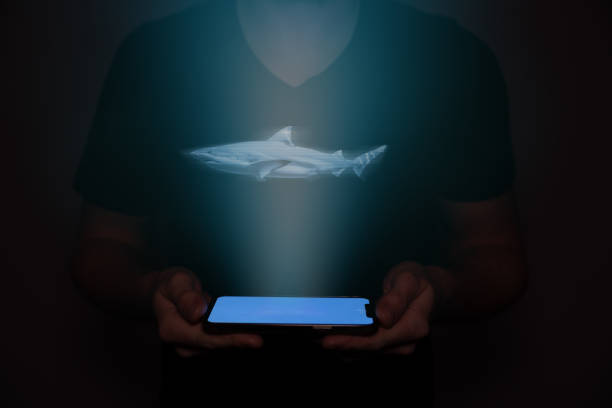 istock A man in the future holds a on which a shark is projected. New technology. 1484505567