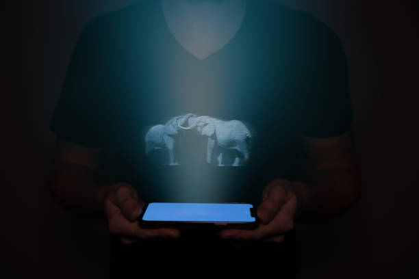 istock A man in the future holds a on which an elephant is projected. New technology. 1484505568