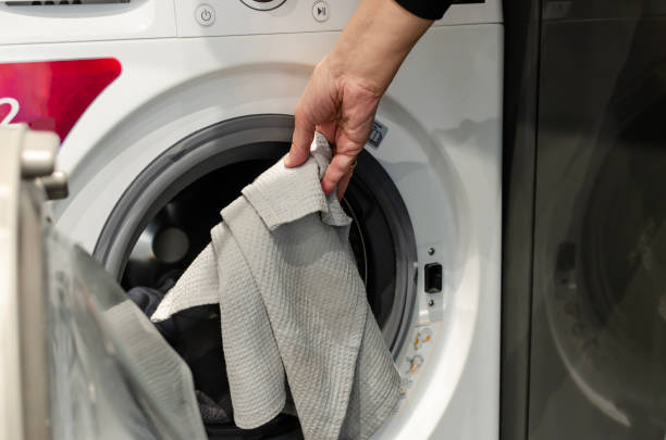 istock A man's hand puts dirty things in the washing machine 1484505733
