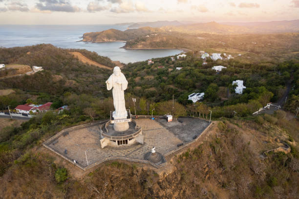 istock Jesus Christ statue in gold color sunrise light 1484505991