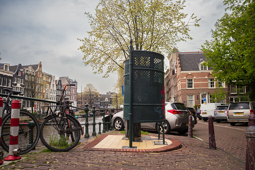 April 21, 2023, Amsterdam, Netherlands Colorfully Decorated Bike on a Bridge Over a Canal in the center of Amsterdam