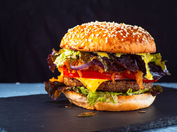 istock Vegan burger on a slate plate. dark background. Horizontal orientation. 1484525143