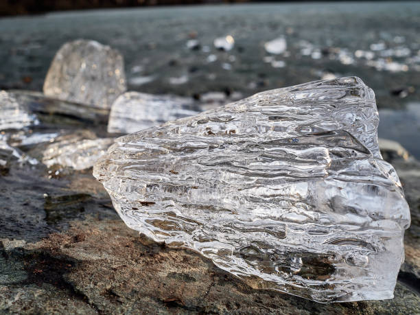 istock Natural crystal clear melting ice cubes on rock and reflection water surface 1484525507
