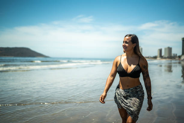 istock Young woman taking a walk by the beach 1484525683