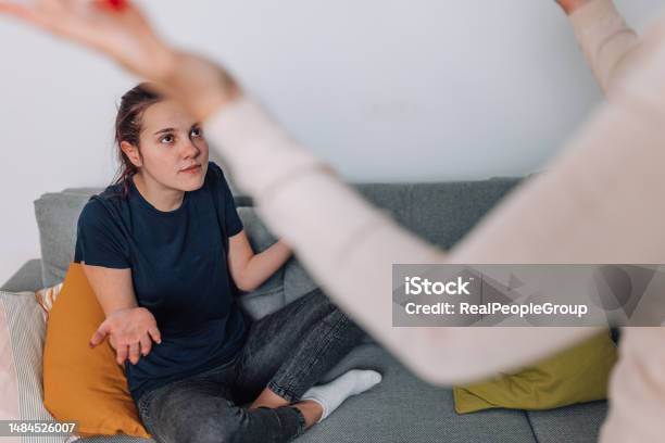 Mother Dealing With Disobedient Daughter In Living Room Stock Photo - Download Image Now