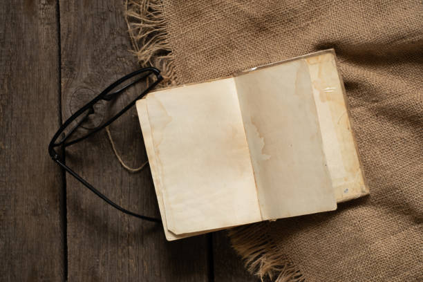 istock open blank book and glasses lie on a wooden table 1484549235