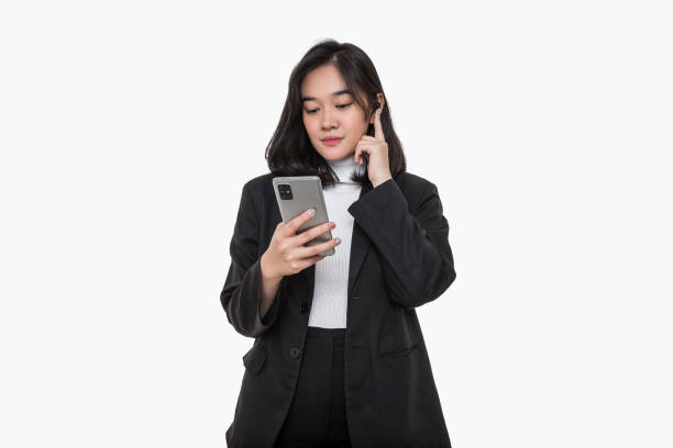 istock Asian women in a black suit, holding a mobile and her ear, using ear buds. 1484552813