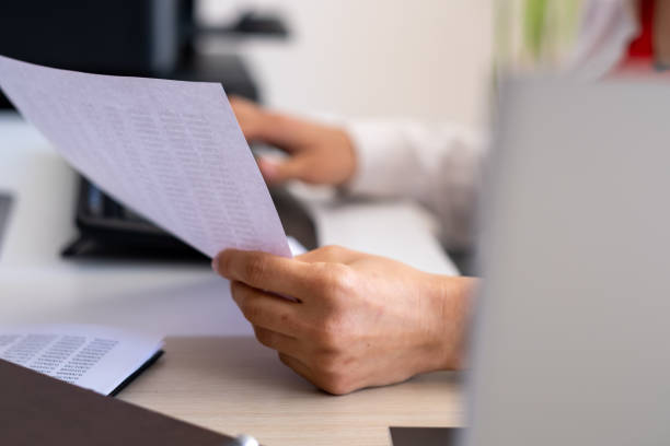 istock close-up of woman's hands typing on computer in office 1484557723
