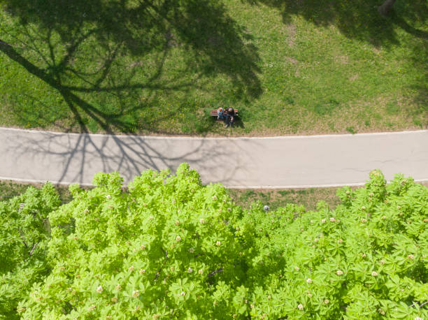 Man and woman together in public park on sunny springtime day