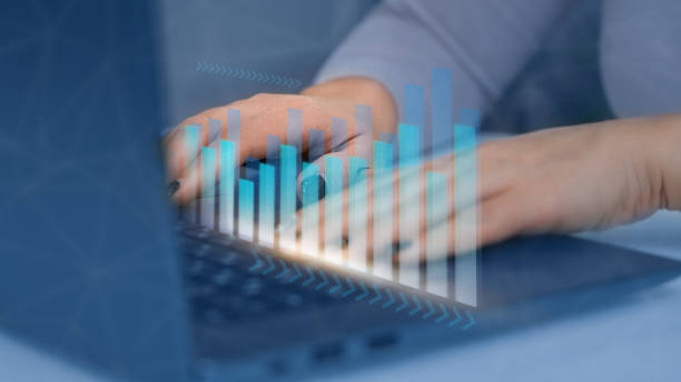 istock Woman hands using laptop with hologram of growing stock graph, conceptual technical analysis, development of digital software technologies, analyzing sales chart and economic growth 1484563285