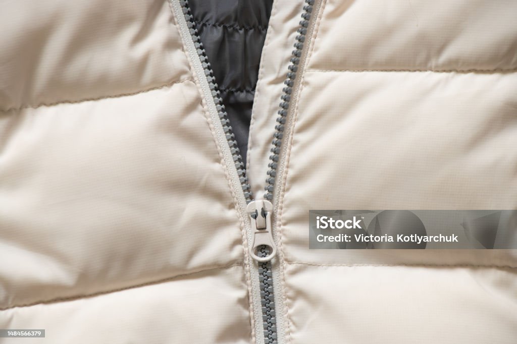 white winter women's padded jacket with zipper as background close up white winter women's padded jacket with zipper as background close-up Abstract Stock Photo