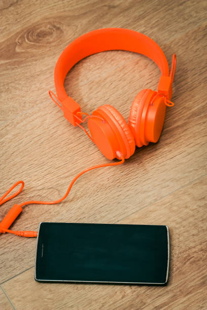 istock Modern orange headset headphones on the table 1484566417