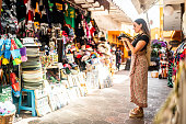 Traveler mid adult woman taking pictures on a local market
