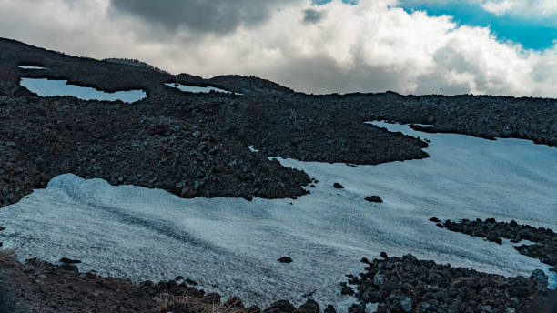 Snow melts on Etna volcano in spring.