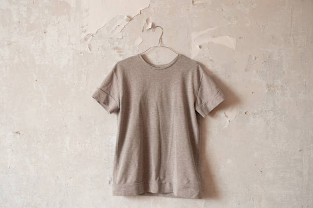 istock women's gray jacket hanging on a hanger on a white wall close up 1484567768