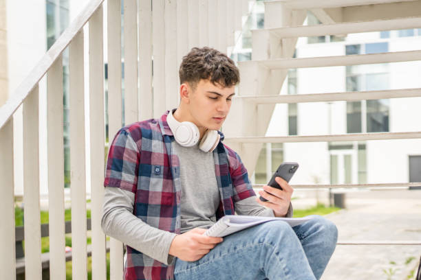 istock Young man teenager caucasian student with books read study at campus 1484570209