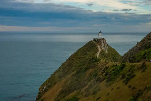 Photo of Nugget Point (Tokata). Iconic promontory on the Otago coast, the Catlins, South Island, New Zealand. Crowned by a lighthouse surrounded by rocky islets (The Nuggets). Home to penguins, gannets, royal spoonbills, fur seals