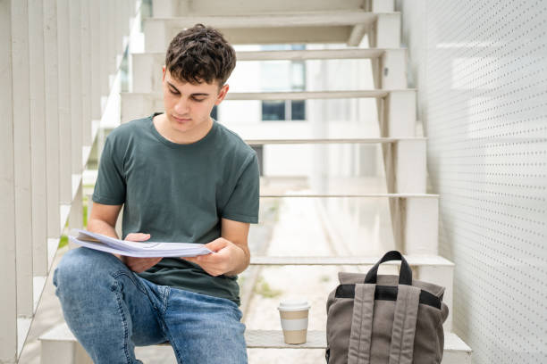 istock Young man teenager caucasian student with books read study at campus 1484570476