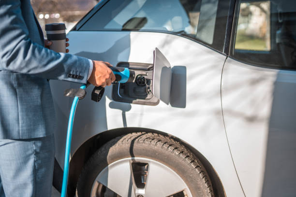 istock Morning Routine, Man Charging his Electric Car 1484573508