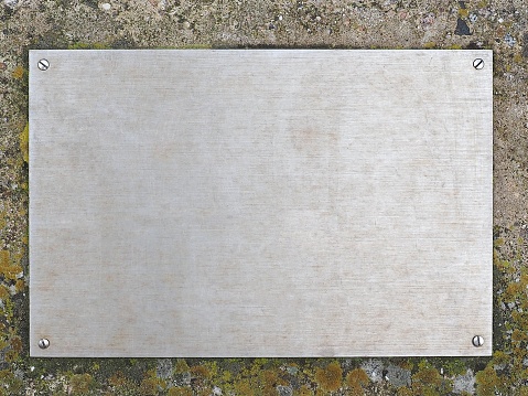 blank steel plaque on concrete wall with copy space