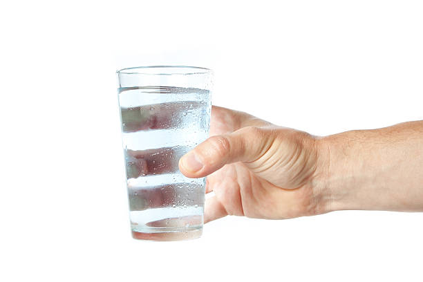 istock Glass of pure water in hand. 148457648