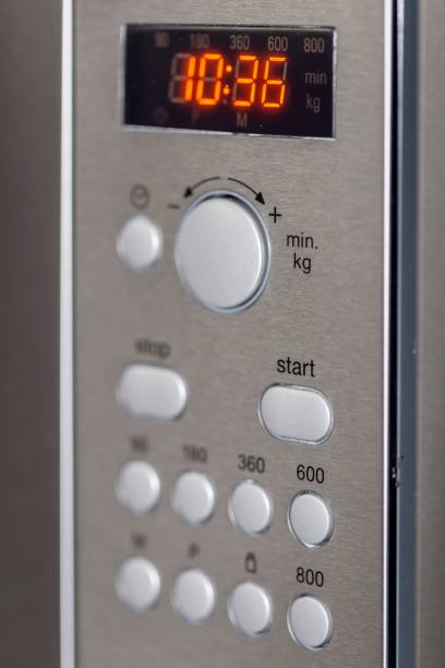 istock Stainless steel digital microwave oven with the timer displayed on the clock face 1484576879
