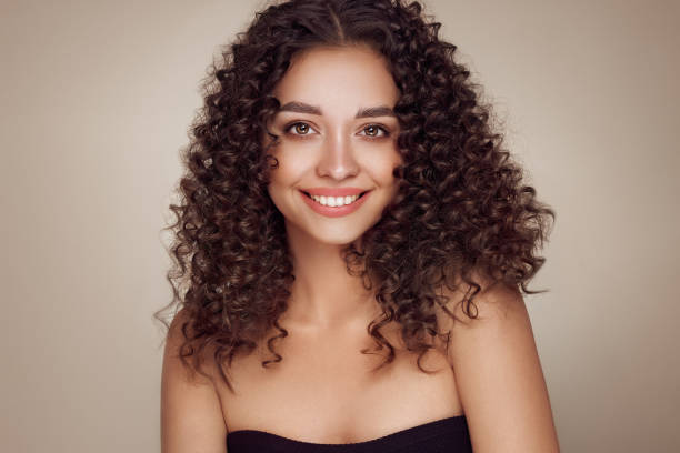 istock Beautiful smiling woman with afro curls 1484579479