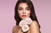 Beautiful young woman with a rose flower