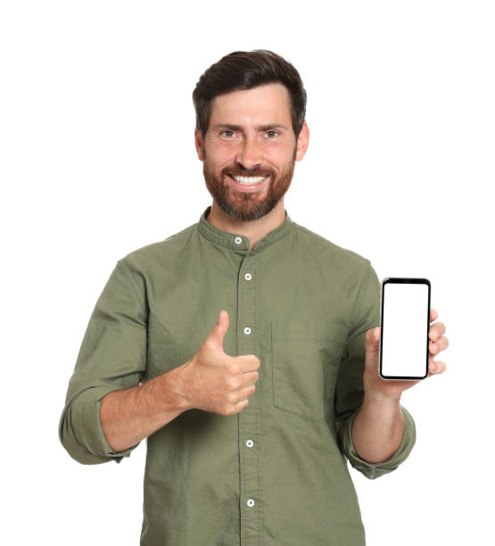 istock Happy man with phone showing thumb up on white background 1484581756