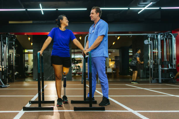 istock Physiotherapist take care patient and prosthetic leg 1484586349