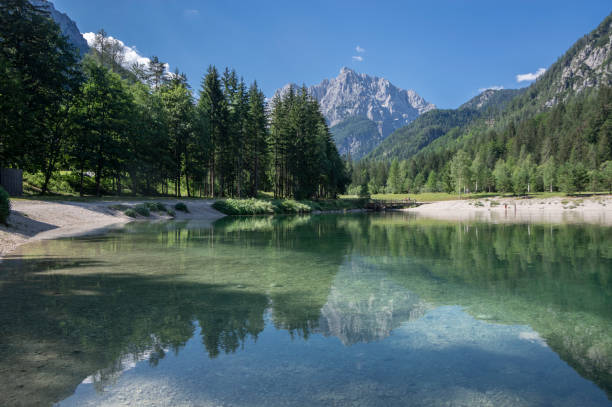 Lake called Jasna in European Slovenian Julian Alps, beautiful water surface with reflections near the road to Vrsic Pass Scenery lake called Jasna in European Slovenian Julian Alps, beautiful water surface with reflections near the road to Vrsic Pass julian alps stock pictures, royalty-free photos & images