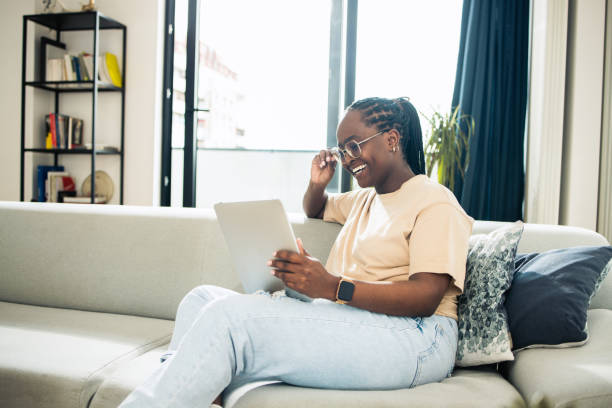 istock Young woman using digital tablet at home 1484588594